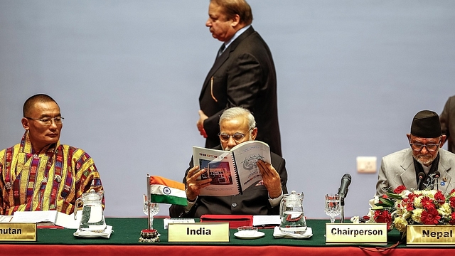 Pakistani Prime Minister Nawaz Sharf walks past Prime Minister Narendra Modi during an earlier SAARC meeting