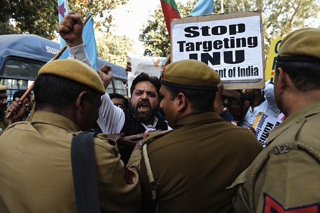 Indian students and activists shout slogans during a protest outside the office of the Indian Minister of Human Resource Development, Smriti Irani, against an attack on Jawaharlal Nehru University (JNU) students in New Delhi on February 16, 2016. A row over the arrest of an Indian student on a controversial sedition charge escalated Friday 15, with students refusing to attend classes and violent scenes at the Delhi court where he was due to appear. Kanhaiya Kumar was arrested on February 12 for alleged seditious behaviour at a rally to mark the third anniversary of a Kashmiri separatist's execution, sparking major protests at Delhi's prestigious Jawaharlal Nehru University (JNU) and other universities. He was brought before a judge on February 15, but violent scuffles broke out in the courtroom where fellow students and journalists had gathered to witness his appearance.  AFP PHOTO / SAJJAD HUSSAIN / AFP / SAJJAD HUSSAIN        (Photo credit should read SAJJAD HUSSAIN/AFP/Getty Images)