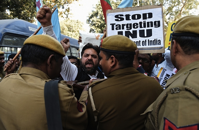 Indian students and activists shout slogans during a protest outside the office of the Indian Minister of Human Resource Development, Smriti Irani, against an attack on Jawaharlal Nehru University (JNU) students in New Delhi on February 16, 2016. A row over the arrest of an Indian student on a controversial sedition charge escalated Friday 15, with students refusing to attend classes and violent scenes at the Delhi court where he was due to appear. Kanhaiya Kumar was arrested on February 12 for alleged seditious behaviour at a rally to mark the third anniversary of a Kashmiri separatist’s execution, sparking major protests at Delhi’s prestigious Jawaharlal Nehru University (JNU) and other universities. He was brought before a judge on February 15, but violent scuffles broke out in the courtroom where fellow students and journalists had gathered to witness his appearance.  AFP PHOTO / SAJJAD HUSSAIN / AFP.