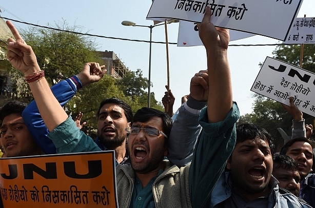 Indian right-wing activists shout slogans during a protest outside Jawaharlal Nehru University (JNU) in New Delhi on February 16, 2016. A student union leader Kanhaiya Kumar was arrested on Friday for allegedly shouting anti-India slogans at a rally in protest against a Kashmiri separatist's execution three years ago. AFP PHOTO / Money SHARMA / AFP / MONEY SHARMA        (Photo credit should read MONEY SHARMA/AFP/Getty Images)