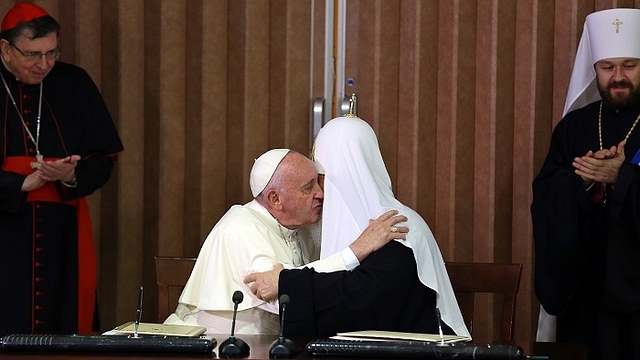 Pope Francis (L) and the head of the Russian Orthodox Church, Patriarch Kirill (R), kiss during a historic meeting in Havana on February 12, 2016. Pope Francis and Russian Orthodox Patriarch Kirill kissed each other and sat down together Friday at Havana airport for the first meeting between their two branches of the church in nearly a thousand years. AFP PHOTO / POOL - Alejandro Ernesto / AFP / POOL / ALEJANDRO ERNESTO        (Photo credit should read ALEJANDRO ERNESTO/AFP/Getty Images)