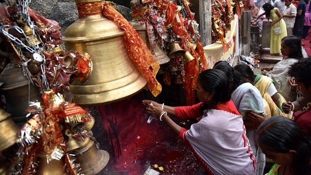 Women worshipping at a Hindu temple.