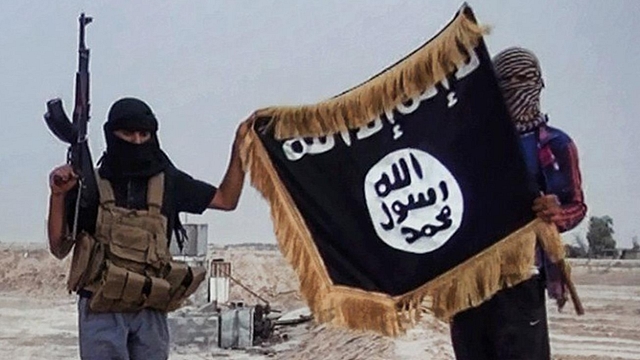 ISIS terrorists holding their flag. (File Photo)