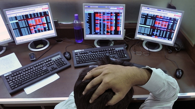 

An Indian stockbroker reacts as he watches share prices on his computer during intraday trade at a brokerage firm in Mumbai on August 3, 2011. Indian shares slid as much as 1.23 percent and below the 18,000-point level in early trade August 3, tracking regional markets on concerns of a weakening global outlook. The benchmark 30-share Sensex index on the Bombay Stock Exchange fell 223.32 points to a day’s low of 17,886.57, before recovering marginally to 17,943.47 but still down 0.92 percent. AFP PHOTO/Indranil MUKHERJEE (Photo credit: INDRANIL MUKHERJEE/AFP/GettyImages)