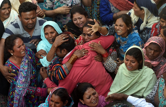 Pakistani Christians mourn as they attend a funeral for a blast victim of the March 27 suicide bombing, in Lahore on March 28, 2016. Pakistan’s army launched raids and arrested suspects after a Taliban suicide bomber targeting Christians over Easter killed 72 people including many children in a park crowded with families. / AFP / ARIF ALI (Photo credit: ARIF ALI/AFP/Getty Images)