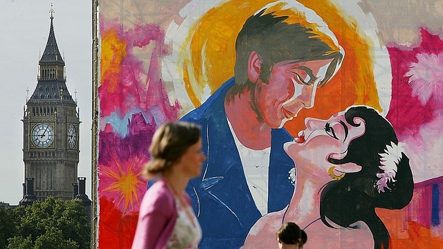 

Commuters pass a giant painting of a Bollywood film poster in Trafalgar Square before heading to work on August 17, 2007 in London, England. The painting will be finished over a period of days during the Indian Festival in Trafalgar Square. (Photo by Cate Gillon/Getty Images)