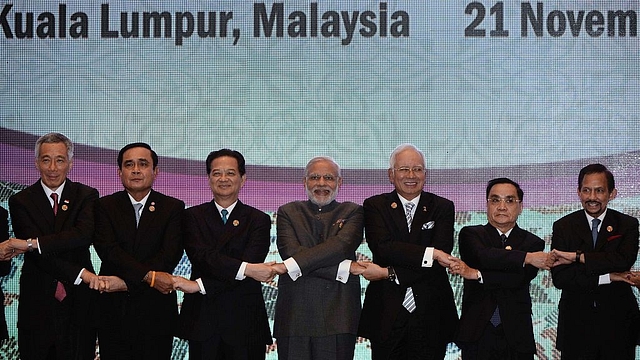 

Prime Minister Narendra Modi (C) joins hands with ASEAN leaders for a group photo during the ASEAN plus India meeting, part of the 27th Association of Southeast Asian Nations (ASEAN) Summit in Kuala Lumpur on November 21, 2015. Asia-Pacific leaders meeting in Malaysia on November 21 condemned the string of Islamic extremist attacks from Paris to Mali, urging an international effort to fight the scourge. Pictured are (L to R) Singapore Prime Minister Lee Hsien Loong, Thailand’s Prime Minister Prayut Chan-O-Cha, Vietnam’s Prime Minister Nguyen Tan Dung, Modi, Malaysia’s Prime Minister Najib Razak, Laos Prime Minister Thongsing Thammavong and Brunei Sultan Hassanal Bolkiah. AFP PHOTO / MANAN VATSYAYANA (Photo credit should read MANAN VATSYAYANA/AFP/Getty Images)