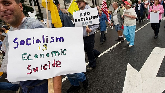 

Demonstrators hold signs during a march by supporters of the conservative Tea Party movement in Washington on September 12, 2010. Several thousand people gathered for the march from the Washington Monument to the US Capitol. AFP PHOTO/Nicholas KAMM (Photo credit should read NICHOLAS KAMM/AFP/Getty Images)