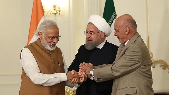 Modi with Iran’s Rouhani and Afghanistan’s Ashraf Ghani, signing the Chahbahar Treaty (Pool / Iran Presidency/Anadolu Agency/GettyImages)