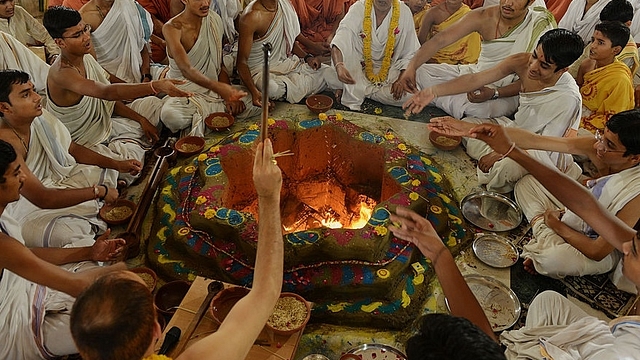 
Indian students and their Gurus,teachers, perform a ritual at a 
Swaminarayan Gurukul Vishwavidya Pratisthanam (SGVP) temple . Getty Images

