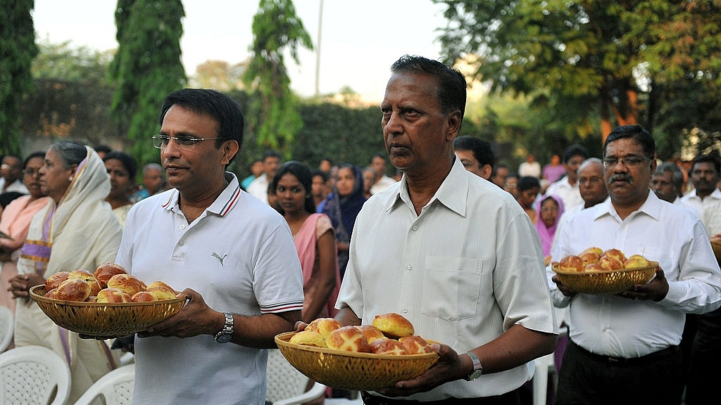 

Indian Catholic Christians carry bread as they proceed towards the altar during the evening mass of the Lord Supper celebrated as Maundy Thursday service at St. Anthony’s Church in Hyderabad on April 1, 2010. The ceremony commemorates the symbolic example of Jesus Christ washing the feet of his apostles at the Lord’s Supper on the eve of his crucifixion. AFP PHOTO/Noah SEELAM (Photo credit: NOAH SEELAM/AFP/Getty Images)