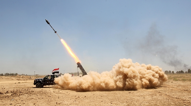 Pro-government forces fighters fire a rocket in the al-Sejar village, in Iraq’s Anbar province, on 27 May 2016, as they take part in a major assault to retake the city of Fallujah, from the Islamic State (IS) group.  AHMAD AL-RUBAYE/AFP/Getty Images