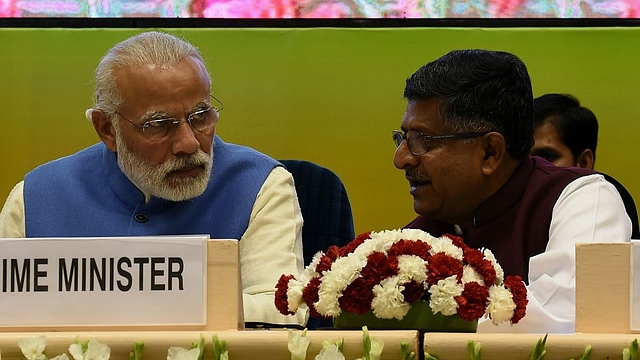 

Indian Prime Minister Narendra Modi (L) talks with Minister of Communication and IT Ravi Shankar Prasad during the launch the National Agriculture Market, an e-market platform at Vigyan Bhawan in New Delhi on April 14, 2016. (Photo credit: MONEY SHARMA/AFP/Getty Images)