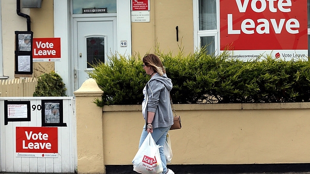 A woman
walks past a house where ‘Vote Leave’ boards are displayed in Redcar, north
east England. (Photo credit: SCOTT HEPPELL/AFP/Getty Images)