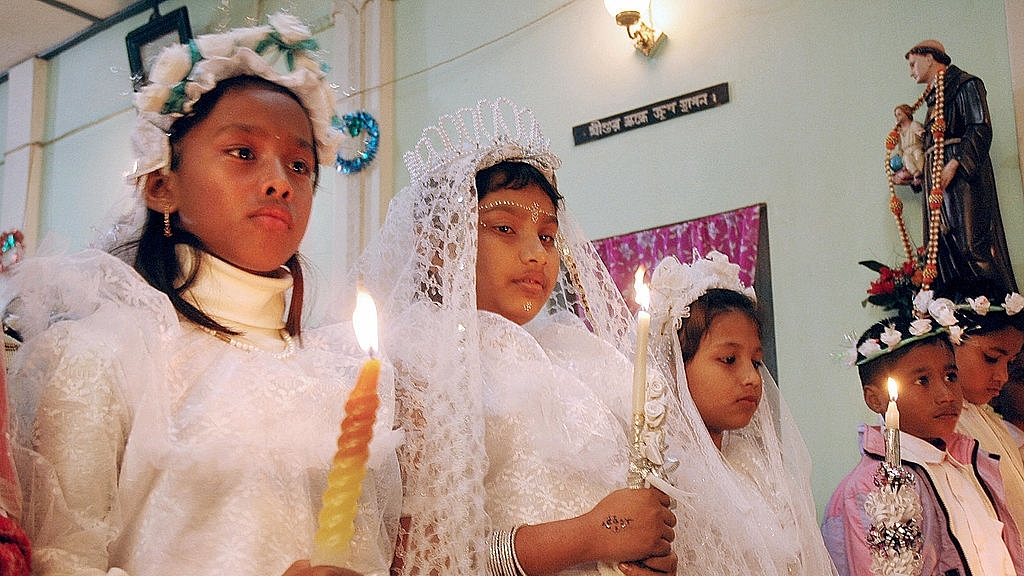 Indian children hold candles in a church (Photo credit: STRDEL/AFP/Getty Images)