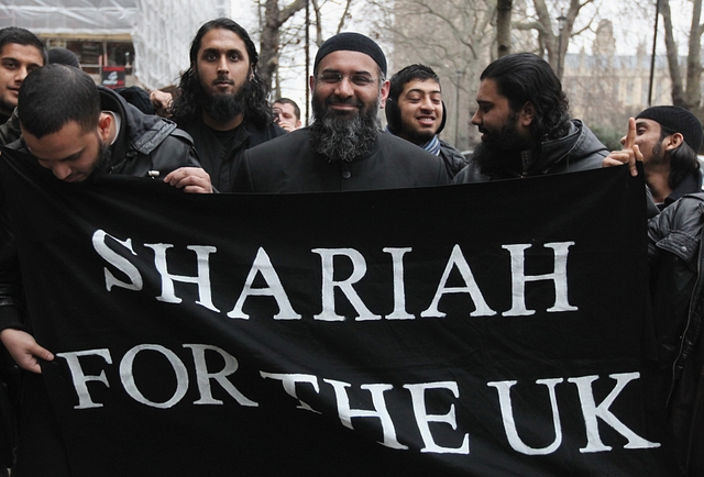 

Islam4UK Spokesman Anjem Choudary (C) leaves a press conference in Millbank Studios on January 12, 2010 in London, England. The radical Islamic group had planned to stage a march through Wootton Bassett to honour Muslims who have been killed in the conflict in Afghanistan, but have been prevented from doing so, under counter-terrorism laws. (Photo by Dan Kitwood/Getty Images)