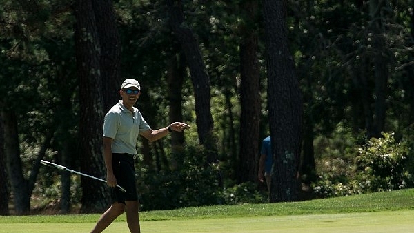 US President Barack Obama reacts to his putt on the first green as he plays golf at Farm Neck Golf Club in Oak Bluffs, Massachusetts on the island of Martha’s Vineyard August 7, 2016. (NICHOLAS KAMM/AFP/Getty Images)