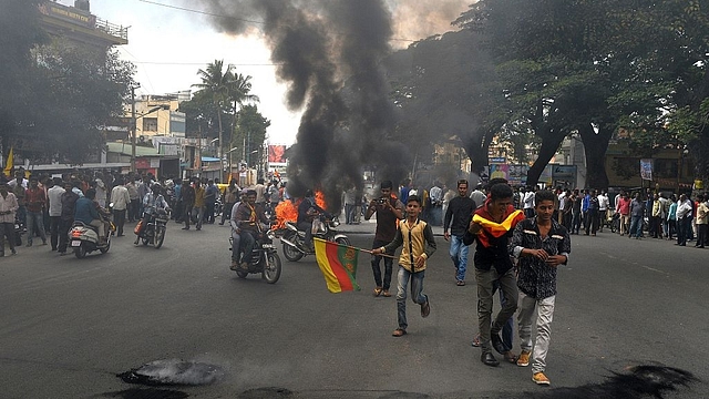 Protesters burn tyres as they blockade traffic on a major
connecting road during a statewide strike in Bangalore over the Cauvery water
issue. Photo credit: MANJUNATH KIRAN/AFP/GettyImages&nbsp;