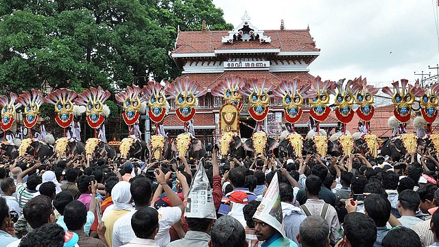 Thousands of Pooram fans watch the processions led by caparisoned
elephants in front of Vadakkunnathan
Temple in  Thrissur. Photo
credit: STRDEL/AFP/GettyImages