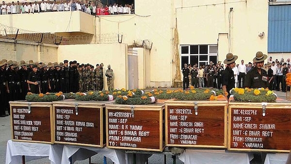 Indian army officers and onlookers pay tribute next to coffins carrying the bodies of soldiers killed in the Uri attack (AFP/Getty Images)