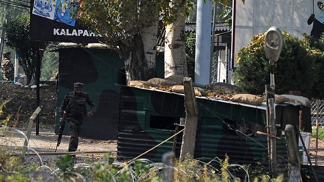 

An Indian army soldier runs through an army brigade headquarters during a gunbattle there between Indian army soldiers and rebels near the border with Pakistan, known as the Line of Control (LoC), in Uri on September 18, 2016. Militants armed with guns and grenades killed 17 soldiers in a raid September 18 on an army base in Indian-administered Kashmir, the worst such attack for more than a decade in the disputed Himalayan region. / AFP / TAUSEEF MUSTAFA (Photo credit: TAUSEEF MUSTAFA/AFP/Getty Images)