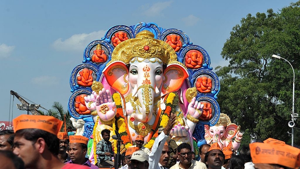 

Indian devotees carry an idol of Ganesh for immersion. Photo credit: NOAH SEELAM/AFP/GettyImages