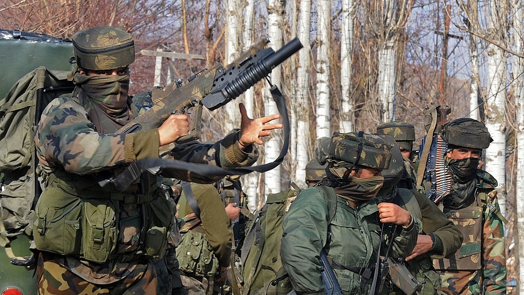 
Indian Army soldiers stand near the scene of a gun battle.<br> (Photo By: 
TAUSEEF MUSTAFA/AFP/Getty Images)

