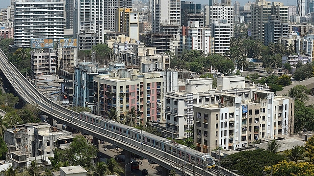 A Mumbai Metro train passes through a residential area (INDRANIL MUKHERJEE/AFP/Getty Images)