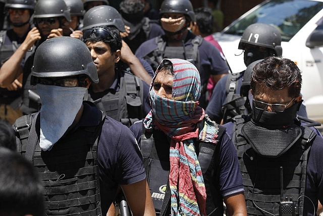 Bangladesh police attend the scene of an operation where they stormed a militant hideout in Narayanganj, around 25 km south of Dhaka (Mahmud Hossain Opu/Getty Images)