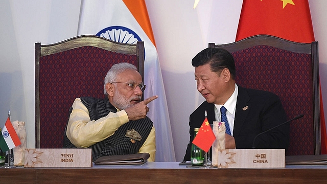 Prime Minister Narendra Modi (L) gestures while talking with China’s President Xi Jingping during the BRICS leaders’ meeting (PRAKASH SINGH/AFP/Getty Images)