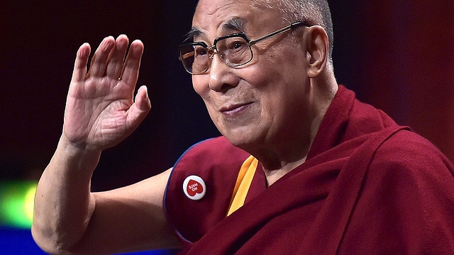 The Dalai Lama
gestures as he arrives for a meeting with young people in France. Photo credit: PATRICK
HERTZOG/AFP/GettyImages