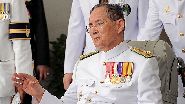 

Thai King Bhumibol Adulyadej waves to a crowd of well-wishers as he marks the 60th anniversary of his coronation in Bangkok. Photo credit: PORNCHAI KITTIWONGSAKUL/AFP/GettyImages