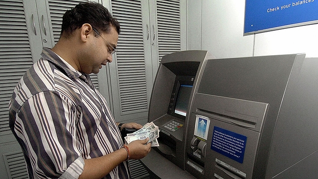 

A bank customer withdraws money from an ATM counter in New Delhi. Photo credit: PRAKASH SINGH/AFP/GettyImages