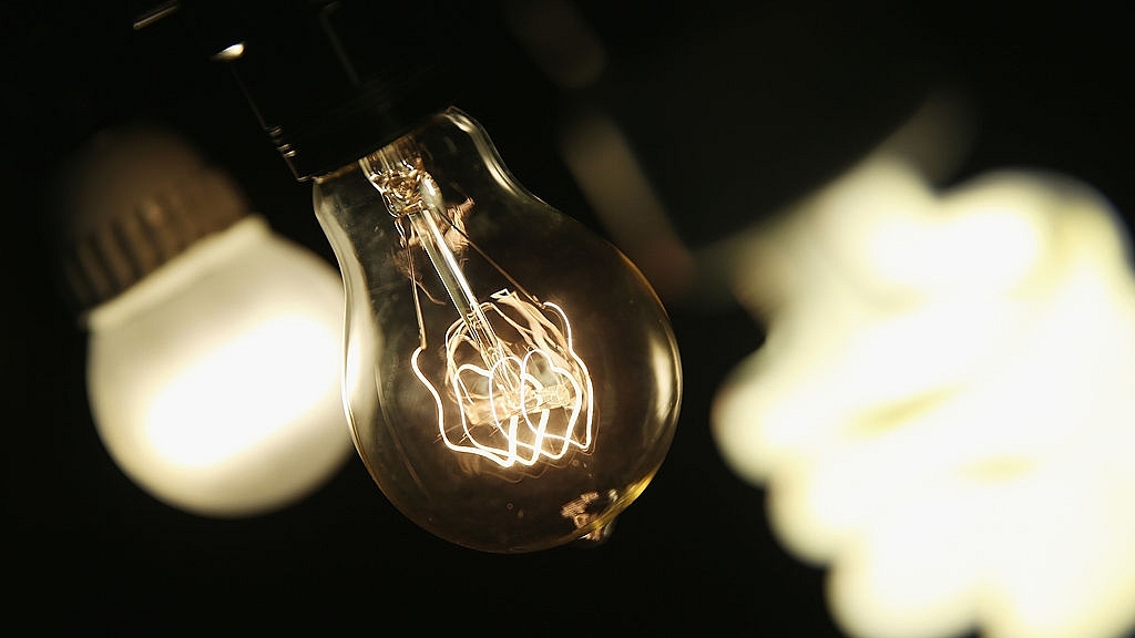 A vintage-style incandescent light bulb (C), with an LED light bulb (L) and a compact florescent (CFL) light bulb (Scott Olson/Getty Images)