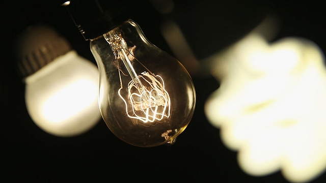 A vintage-style incandescent light bulb (C), with an LED light bulb (L) and a compact florescent (CFL) light bulb (Scott Olson/Getty Images)