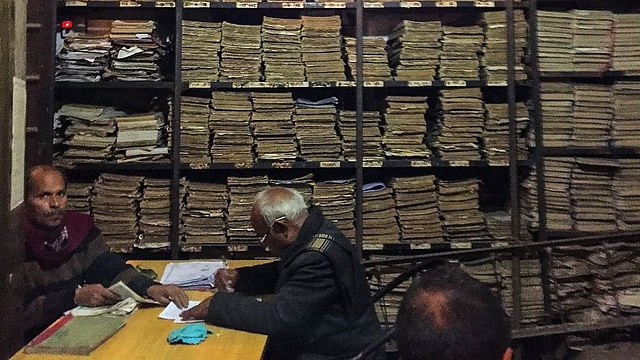 
Indian government 
employees work on registration notary paper. (Photo Credit: CHANDAN 
KHANNA/AFP/Getty Images)

