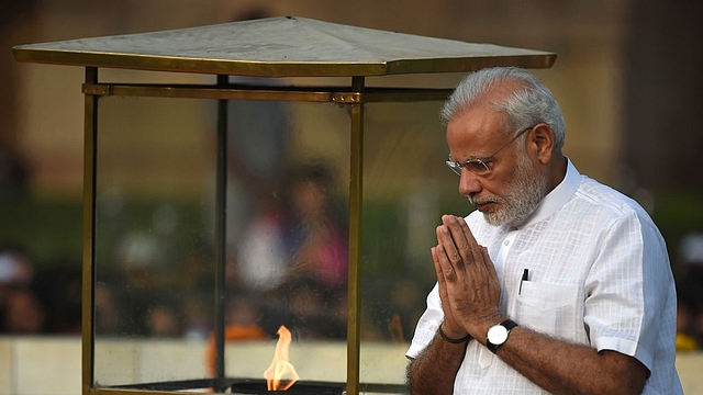 Prime Minister Narendra Modi pays tribute on the 147th Birth Anniversary of Mahatma Gandhi at Rajghat in New Delhi. (PRAKASH SINGH/AFP/Getty Images)