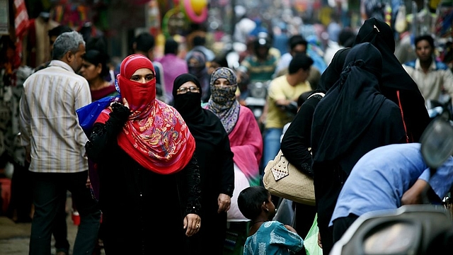 Muslim shoppers walk through a market in Bhopal. Photo credit: MONEY SHARMA/AFP/GettyImages