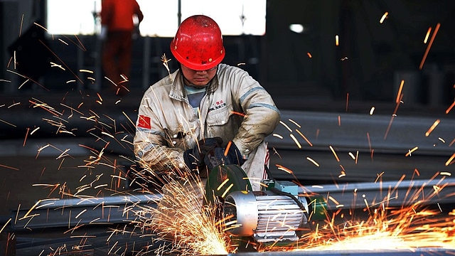 A
worker polishing a piece of work at a structural steelworks company in Rizhao,
in eastern China’s Shandong province.  Photo
credit: STR/AFP/GettyImages