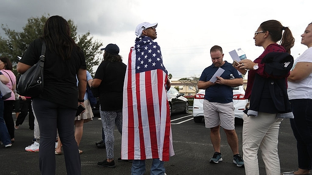 A Hillary supporter draped in the American flag (Joe Raedle/Getty Images)&nbsp;