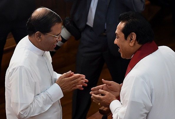 Sri Lankan President Maithripala Sirisena, left, talks with former president Mahinda Rajapakse. Photo credit: Ishara S Kodikara/AFP/GettyImages