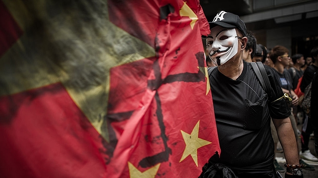 
A man wears a mask of an anonymous hacker. (Photo Credit: PHILIPPE 
LOPEZ/AFP/GettyImages)

