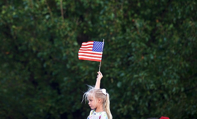  A girl holding the American flag (Mark Makela/Getty Images)