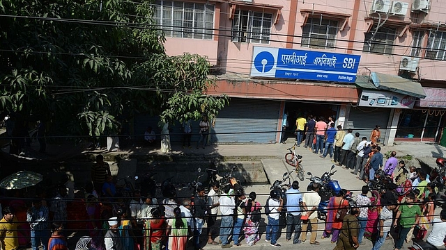 

Indian customers line up next to an ATM at a bank in Siliguri. (DIPTENDU DUTTA/AFP/Getty Images)