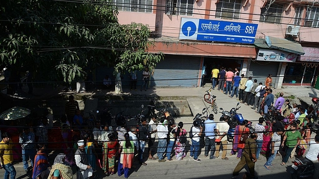 

Indian customers line up at an SBI ATM in Siliguri. Photo credit: DIPTENDU DUTTA/AFP/Getty Images