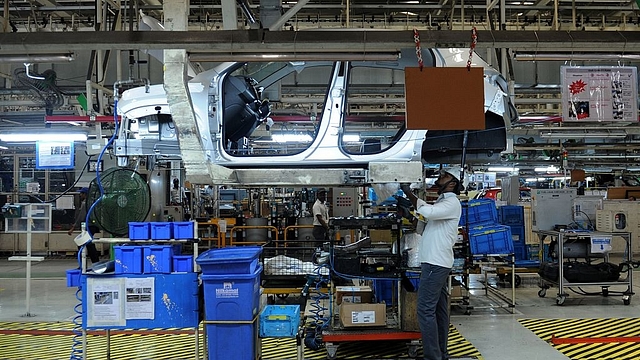 Indian workers labour on assembly lines of components for Datsun Go and Renault Kwid vehicles. (ARUN SANKAR/AFP/Getty Images)