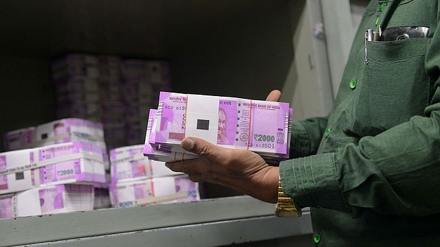 

Stacks of new 2,000 rupee notes. (SAM PANTHAKY/AFP/Getty Images)