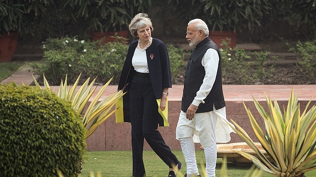 British Prime Minister Theresa May and Indian Prime Minister Narendra Modi walk through the gardens of Hyderabad House. (Dan Kitwood/Getty Images)