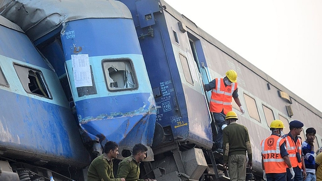 

Indian rescue workers search for survivors in the wreckage of Patna-Indore express train. (SANJAY KANOJIA/AFP/GettyImages)