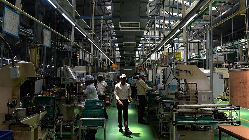 Workers manage machines at a factory of Sona Koyo Steering Systems in Dharuhera, south of New Delhi. (Chandan Khanna/AFP/Getty Images)